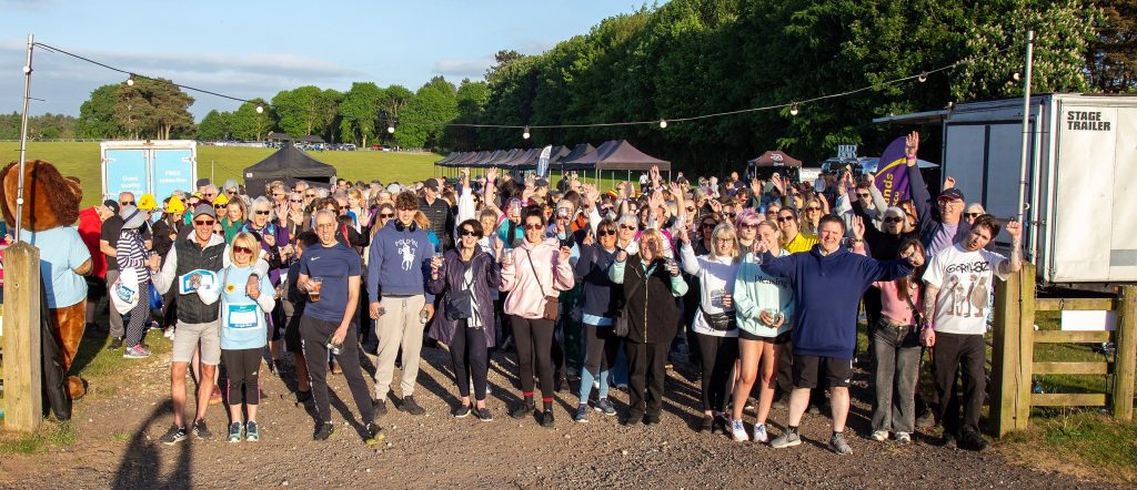 Photo of a large group of Starlight Walk participants waving before beginning the walk
