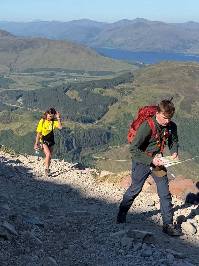 Ben leads the way to the Ben Nevis summit followed by Maria.
