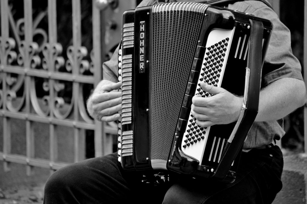 Accordion being played in black and white