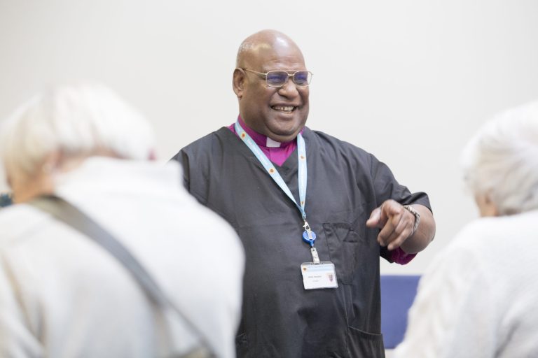 Photo of Hospice Chaplain Willie laughing and interacting with visitors