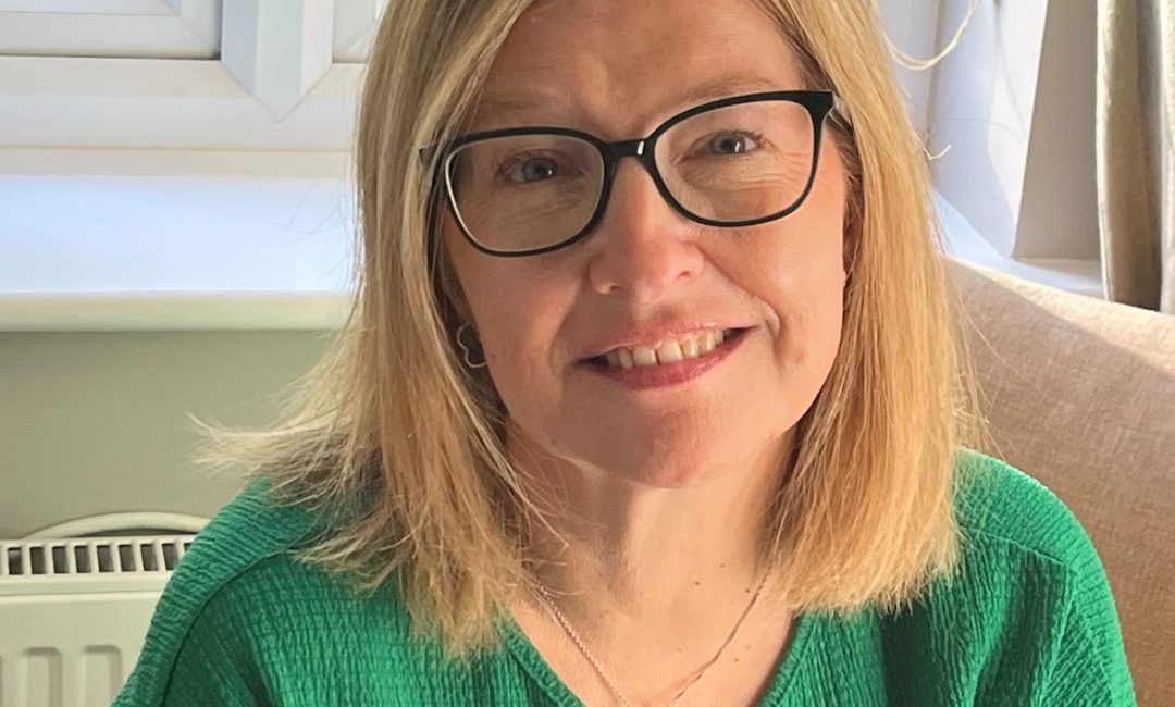 Headshot of Jane Bourne, who is smiling directly at the camera